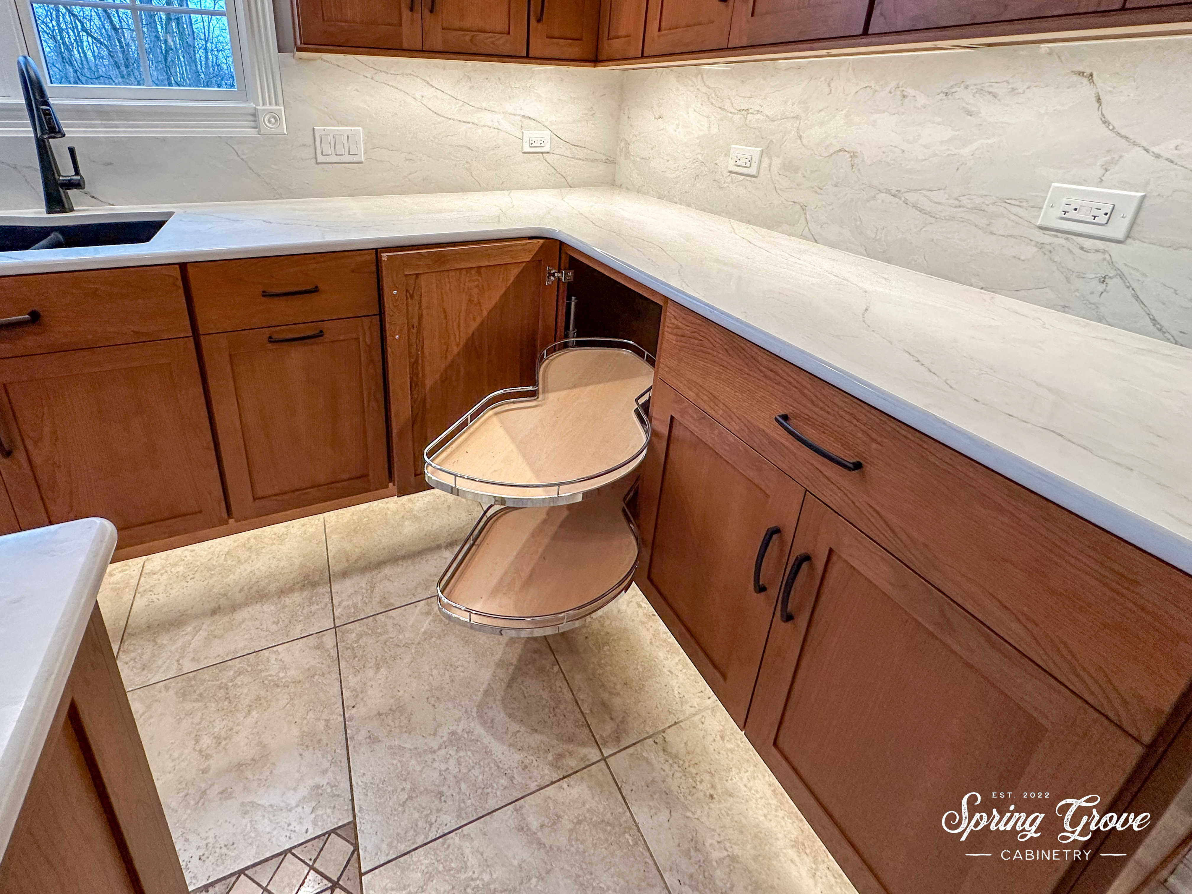 Instead of a lazy-suzan corner cabinet, the homeowners' selected a corner cabinet with soft close pull-out shelves that make the most of the space.