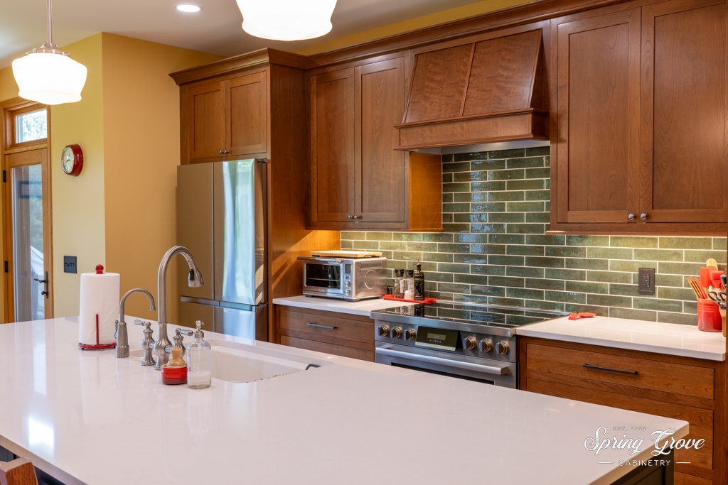 The cherry inset hood perfectly compliments the rest of the cabinetry. 