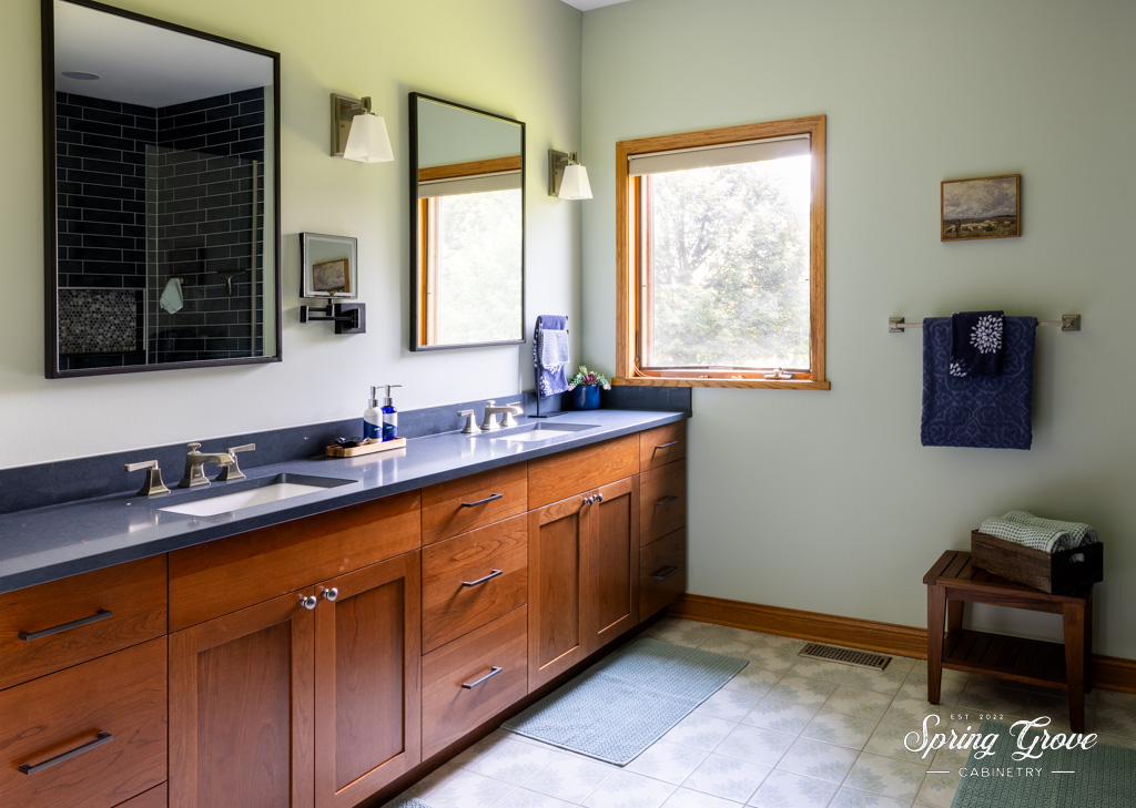 The master bathroom includes two vanities with cherry inset cabinetry and counter space for days.