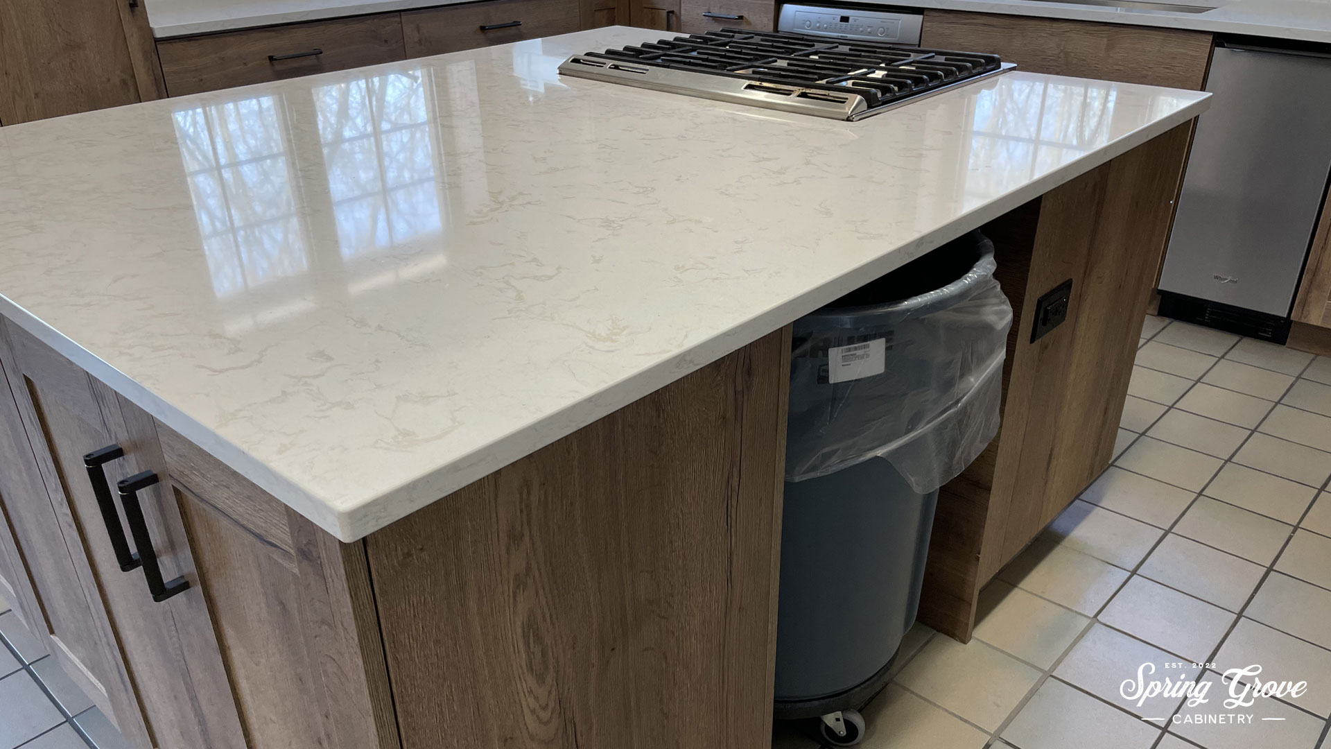 Large island with over-sized trash and removable panels.