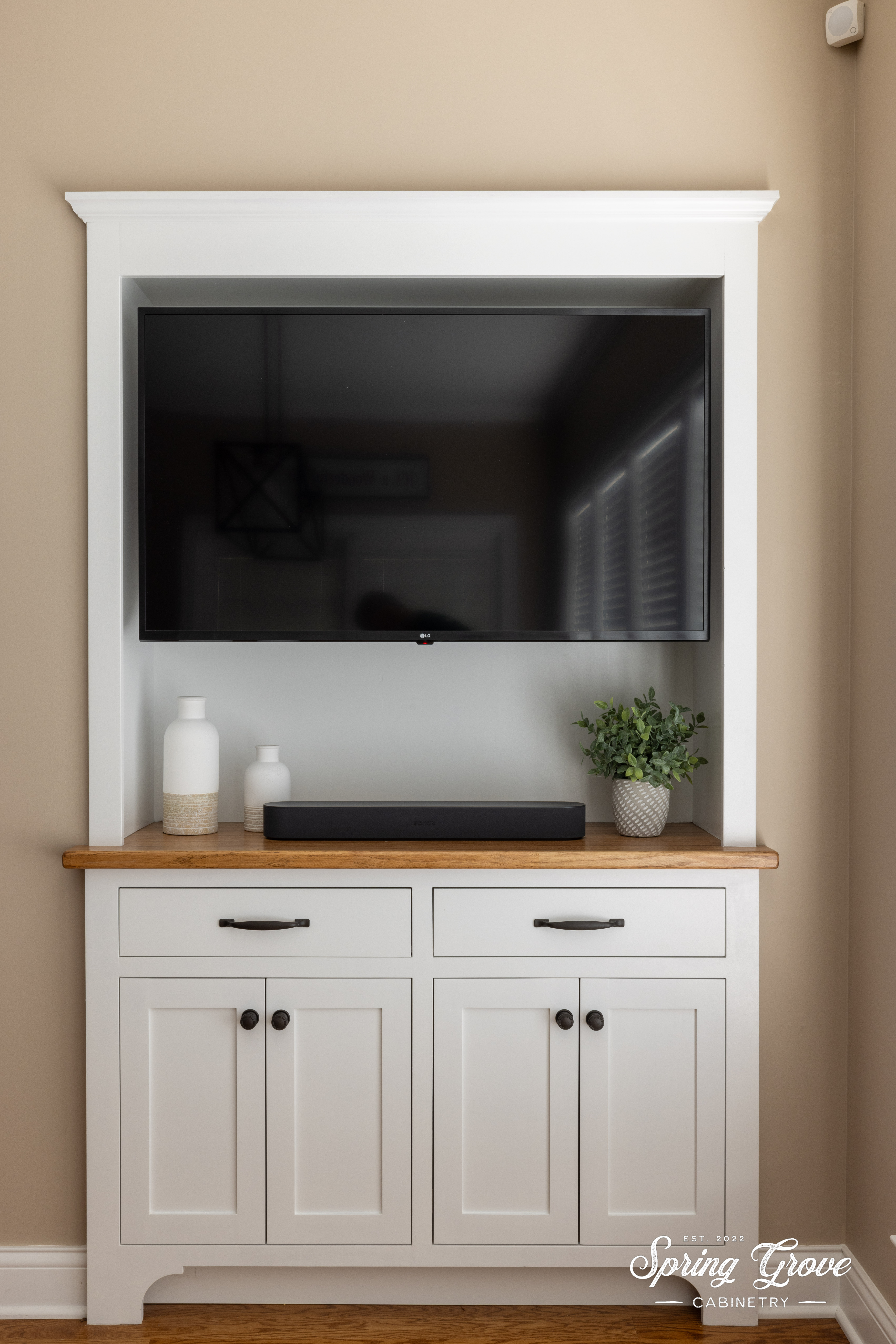 This custom built-in cabinet is a great way to recess the TV and hide the electronics. The lower cainets hold games for family game nights.