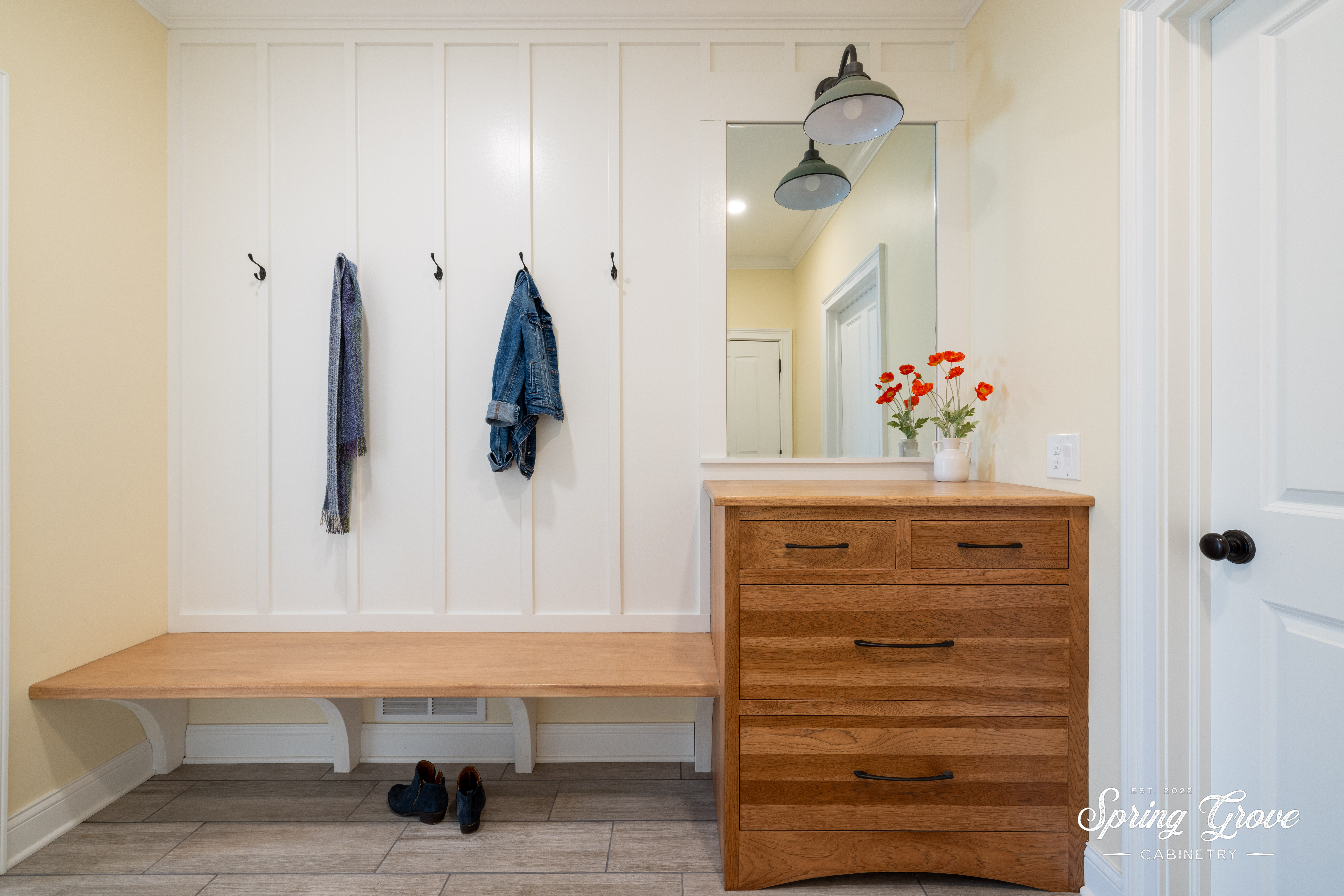This fun mudroom has ample storage under the bench to kick of your shoes. The dresser is perfect storage for hats and gloves.